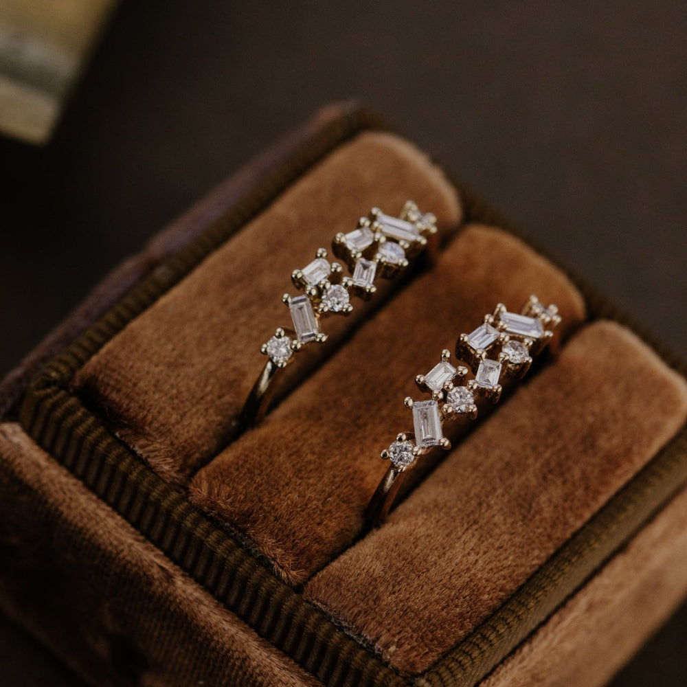 Pair of diamond wedding bands in a brown velvet box.