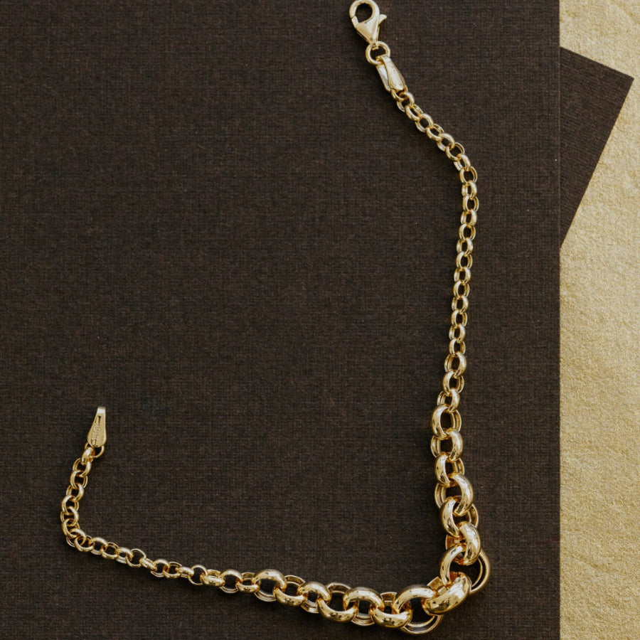 Gold chain bracelet on a brown background