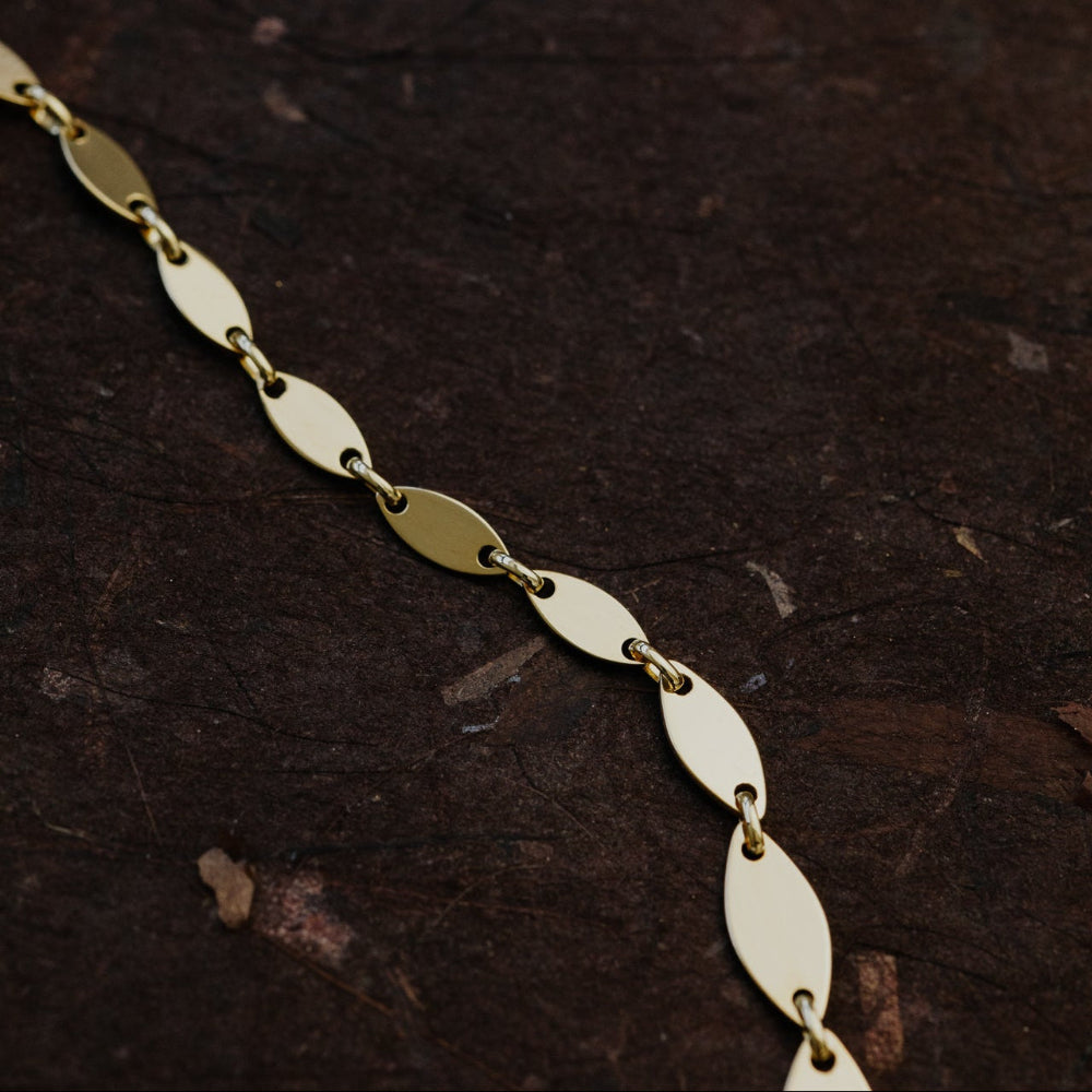 Gold chain on a dark textured surface