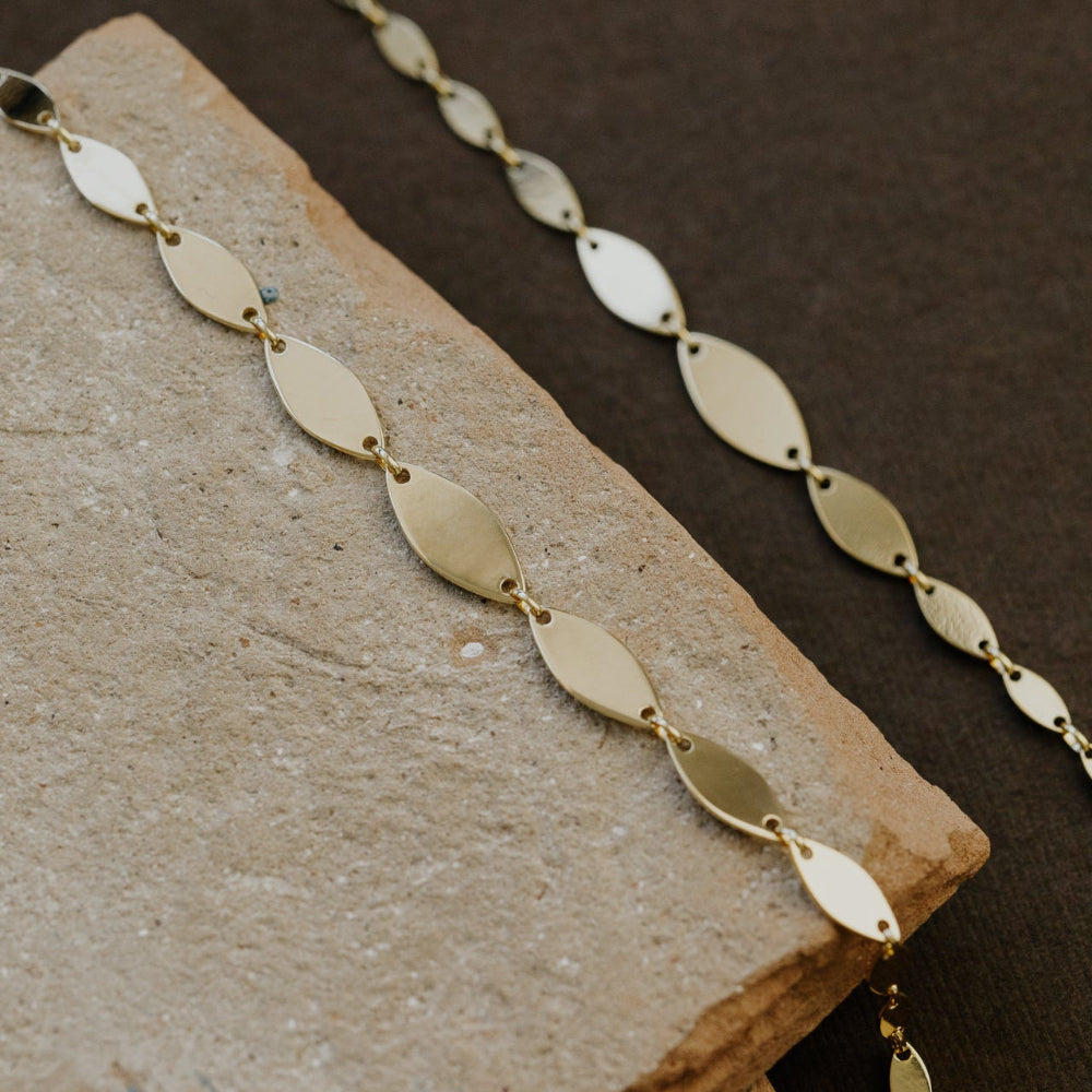 Gold bracelet on a textured surface
