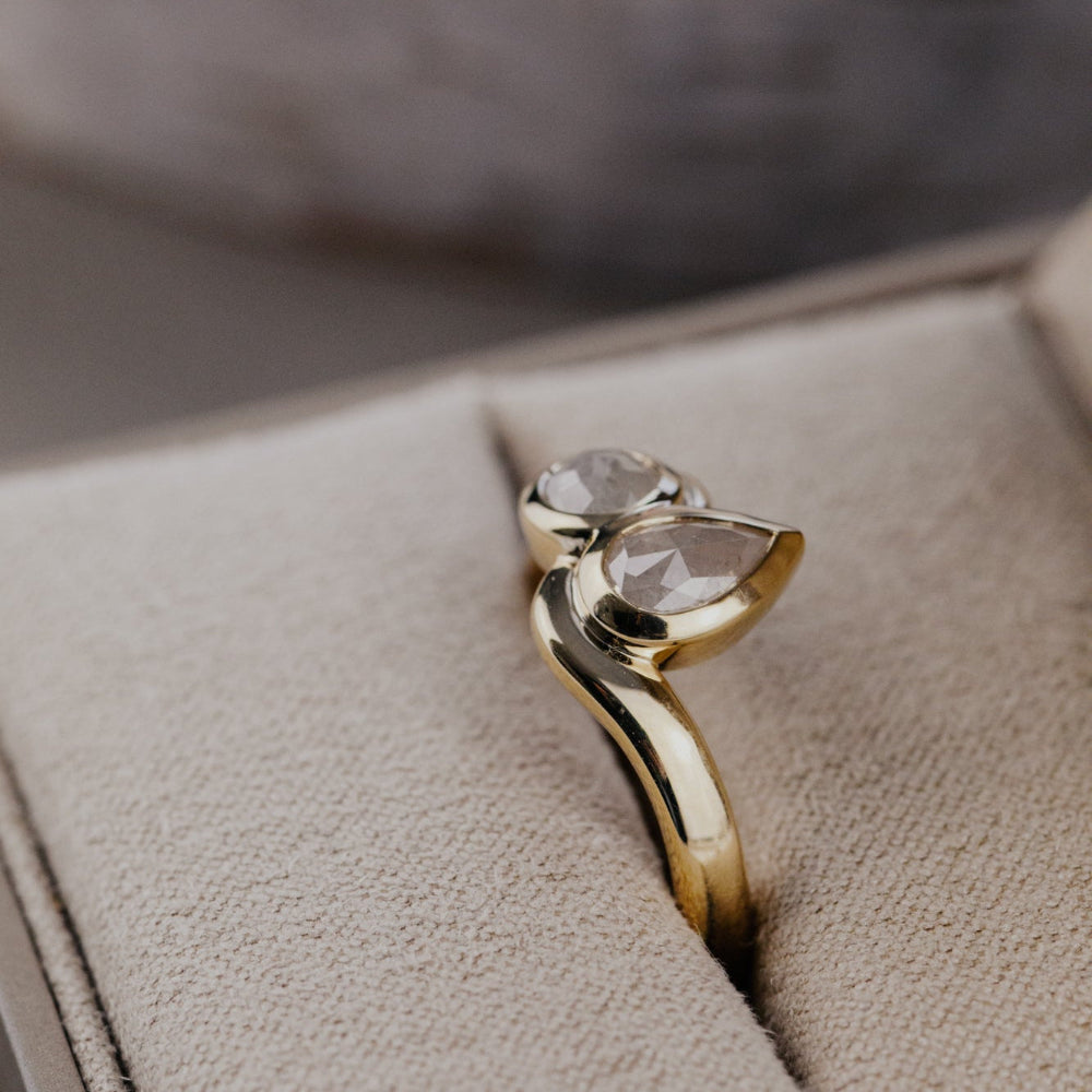 Gold Holland ring with a rustic diamond in an open jewelry box.