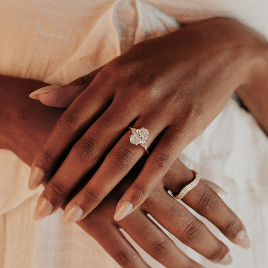 Close up of a person wearing the Lara Oval diamond engagement ring.