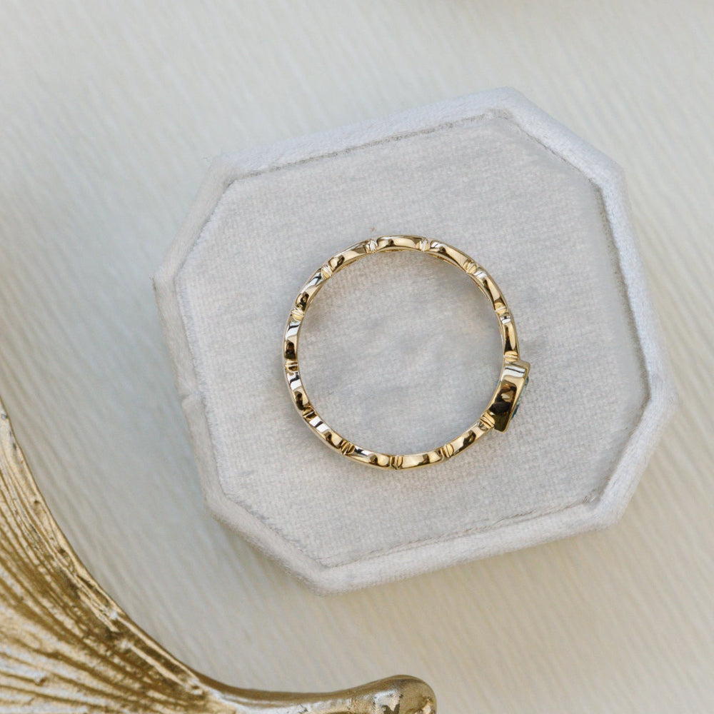 Gold ring on a textured white surface