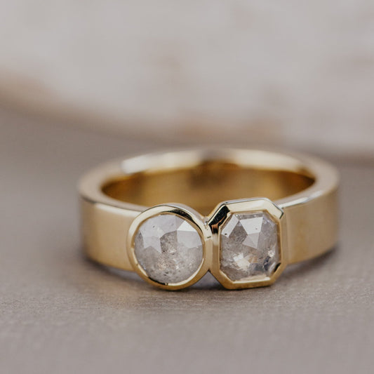 Gold Madison ring with two rustic diamonds on a neutral background.