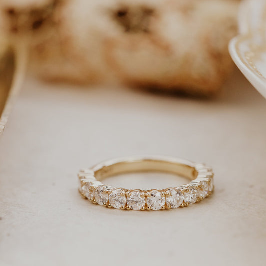 The mini Amara round diamond wedding band set on a white surface.