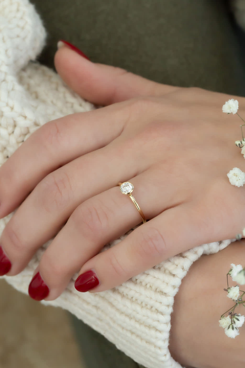 The Mini Bailey .50 ct Round Natural Solitaire on a models hand