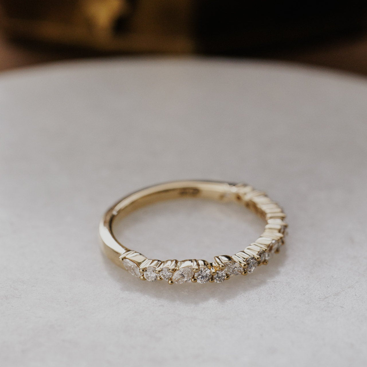 Mini Natalie wedding band with diamonds on a light background.