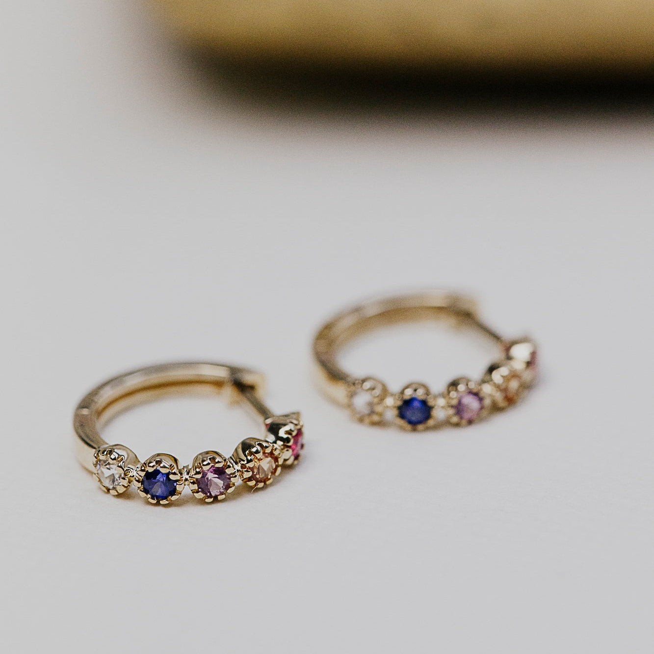Rainbow .36 cttw Sapphire Huggie Earrings in 14k yellow and white gold