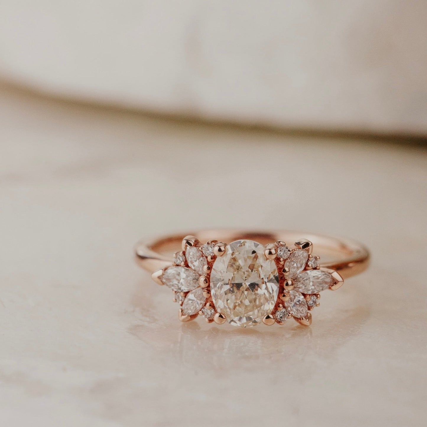 Rose gold ring with a champagne diamond on a light background.