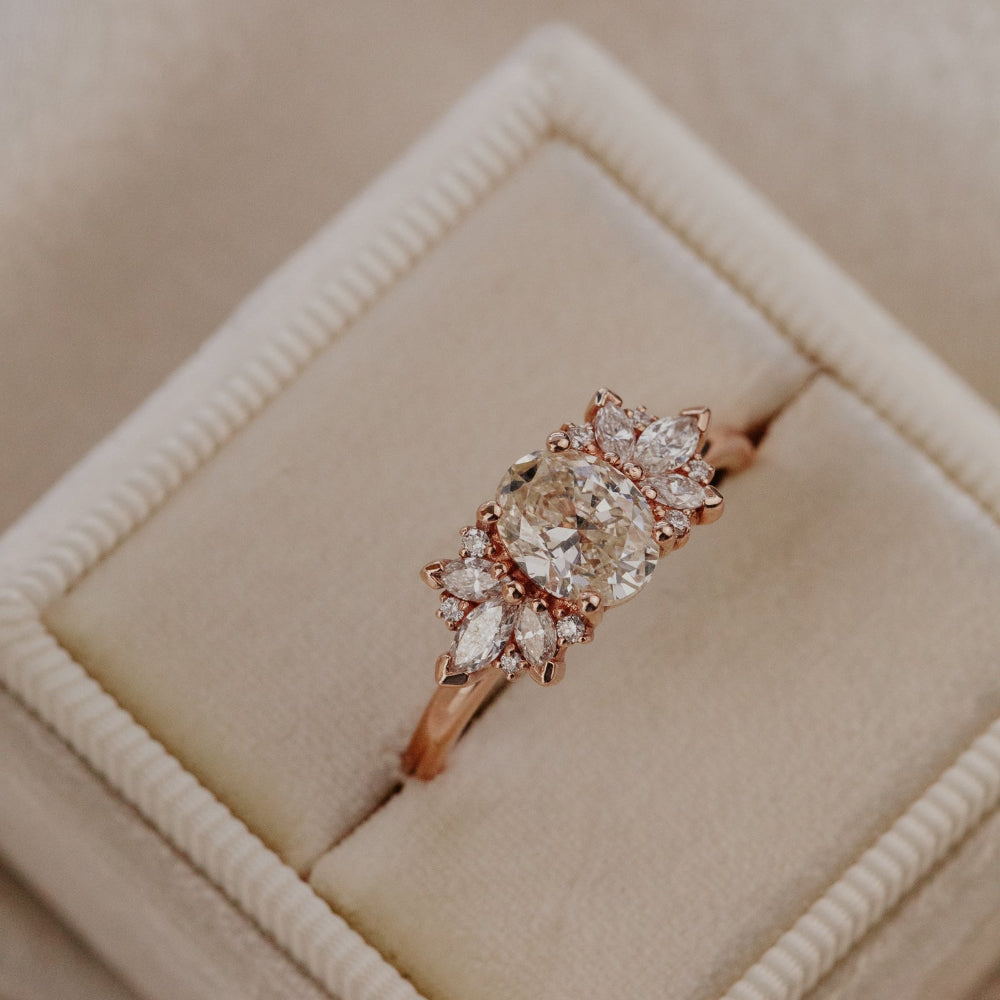 Champagne diamond ring in a beige jewelry box