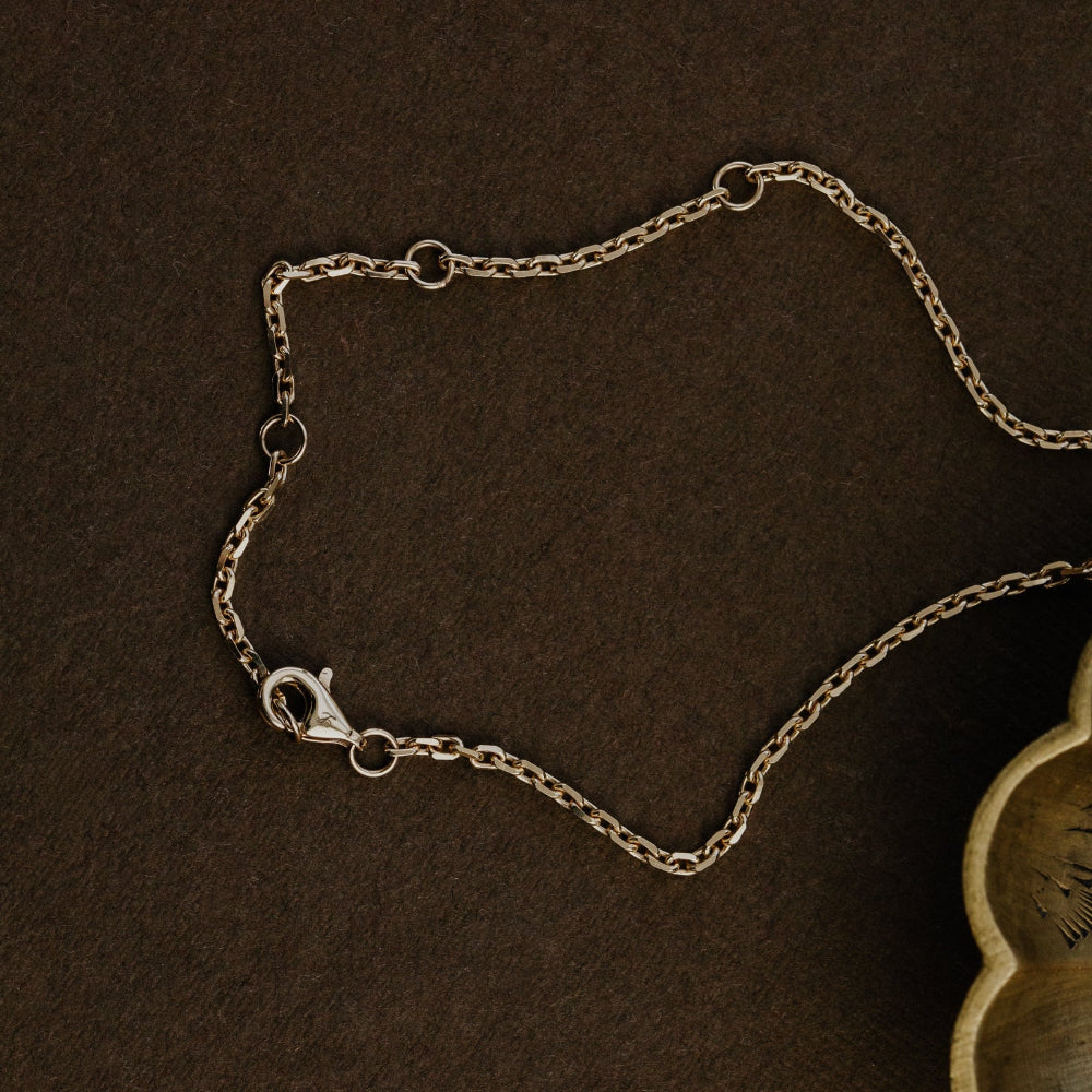 Gold chain on a brown surface