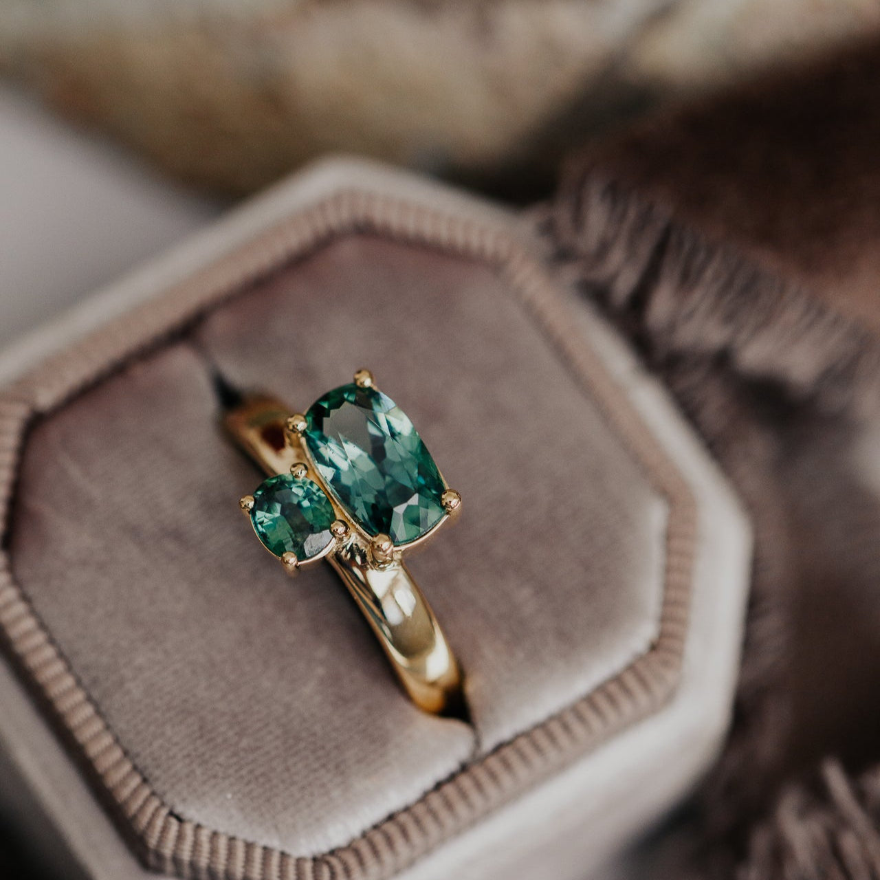 The Reese 1.81 ct Long Cushion and .42 ct Oval Montana Sapphire Ring in a velvet ring box