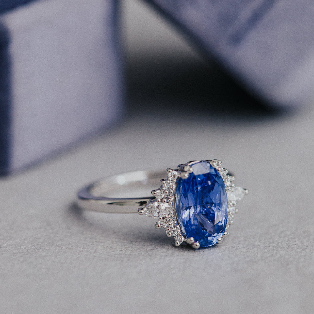white gold engagement ring with a blue sapphire