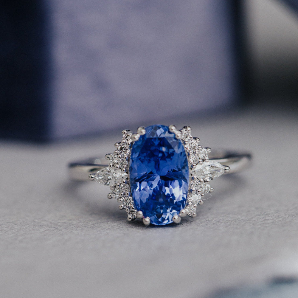 white gold engagement ring with a blue sapphire