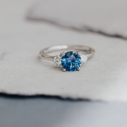 Silver ring with a blue Montana Sapphire on a soft fabric background