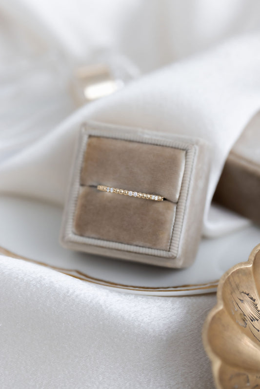 The Jackie Diamond Band in 14k yellow gold in a Sarah O Jewelry velvet ring box