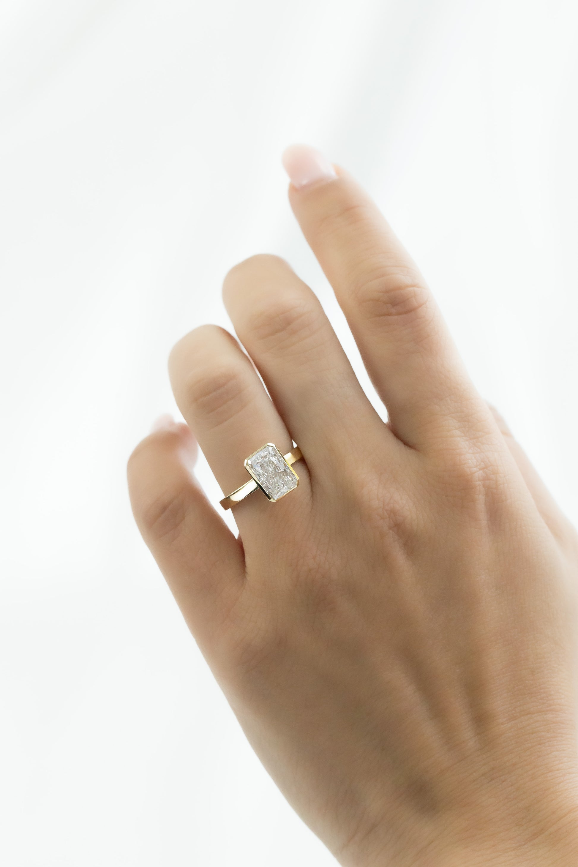The Elena Radiant Cut Solitaire Ring on a models hand