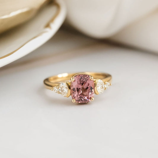 Gold ring with a pink garnet on a light background