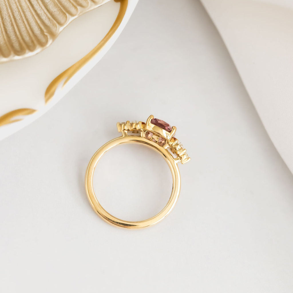 Gold ring with gemstones on a white surface