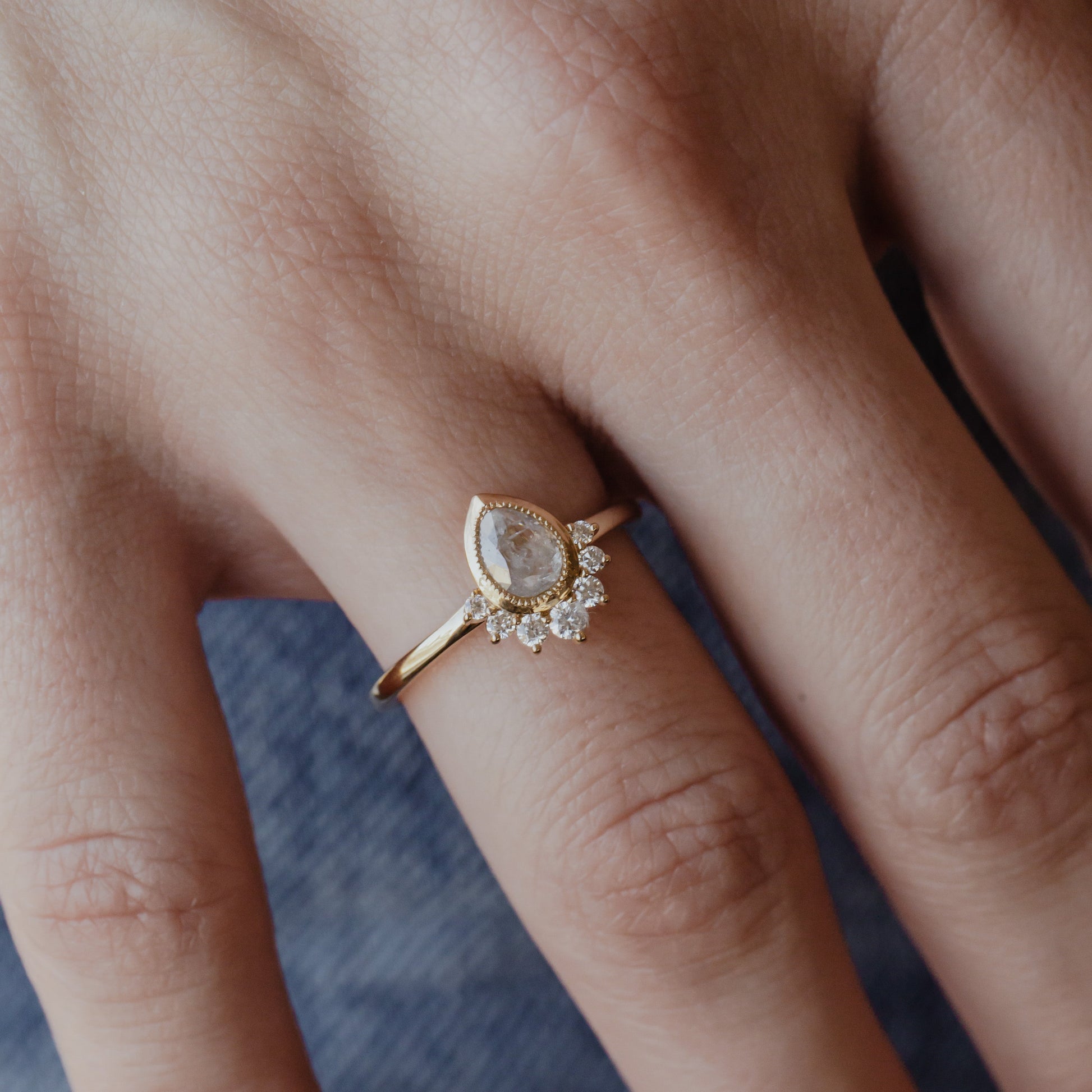 The Acadia .45 ct Pear Rustic Diamond Engagement Ring in 14k yellow gold on a models hand