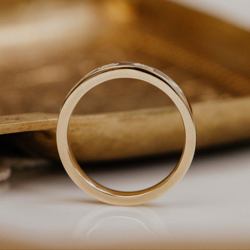 Gold wedding on a textured surface with a blurred background