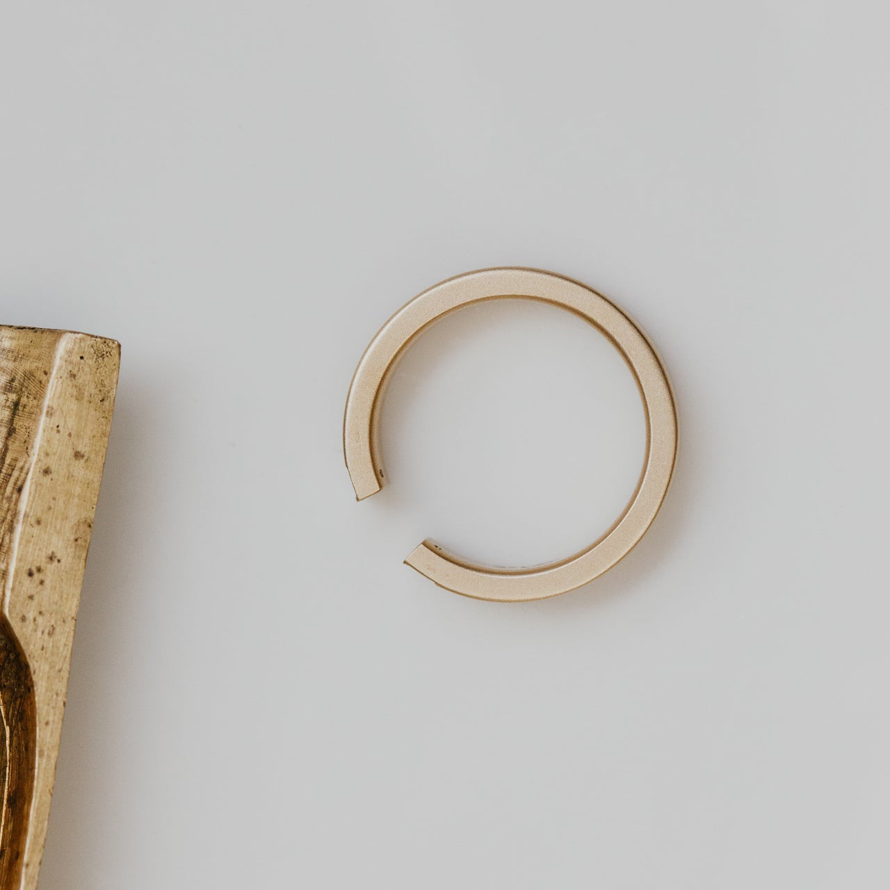 Gold band on a light gray background