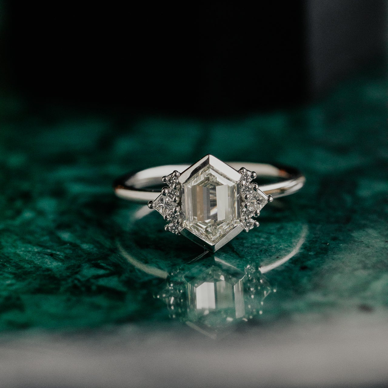 Diamond ring with a green textured background