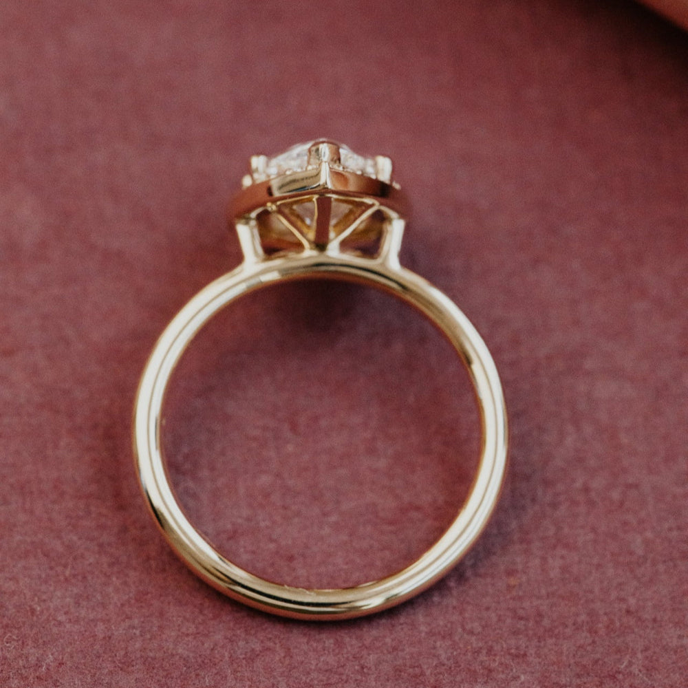 Gold ring with a diamond on a red background