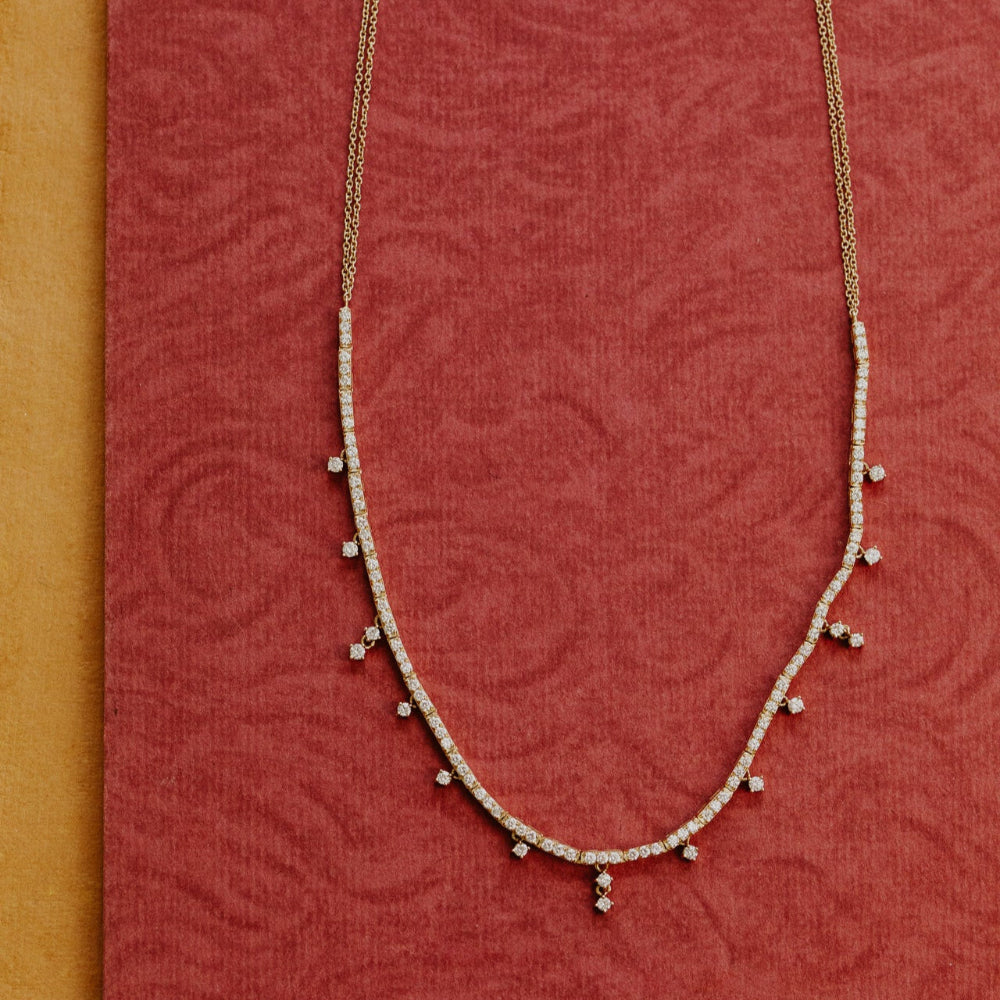 Delicate necklace on a red textured fabric background
