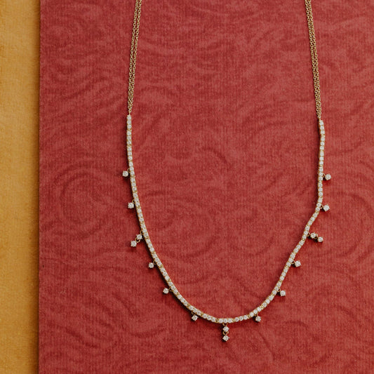 Delicate necklace on a red textured fabric background
