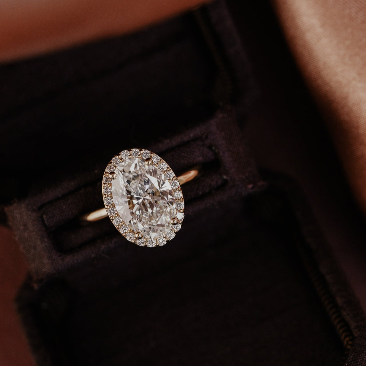 The Audrey oval diamond engagement ring with a diamond halo