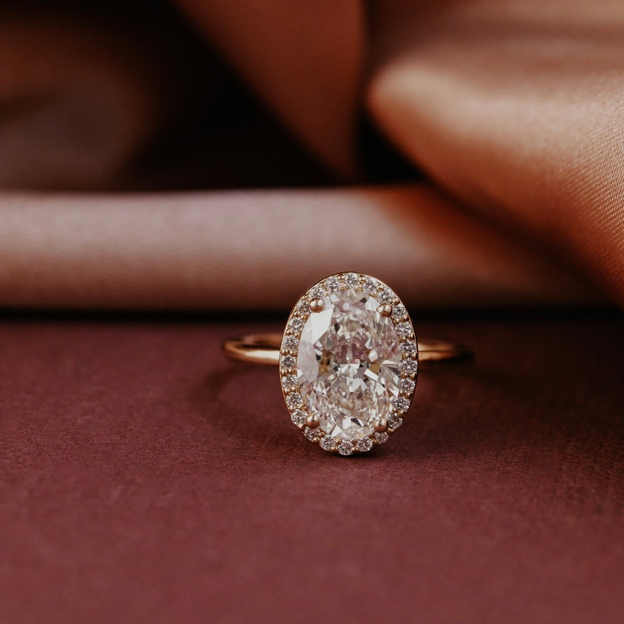 The Audrey oval diamond engagement ring with a diamond halo in 14k yellow gold