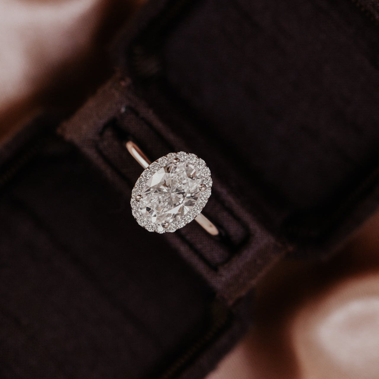 The Audrey oval diamond engagement ring with a diamond halo