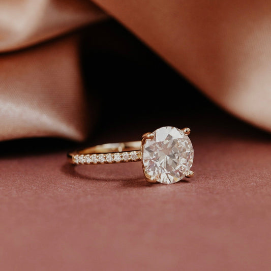 The Jenna Round Diamond Engagement Ring on a pave diamond band