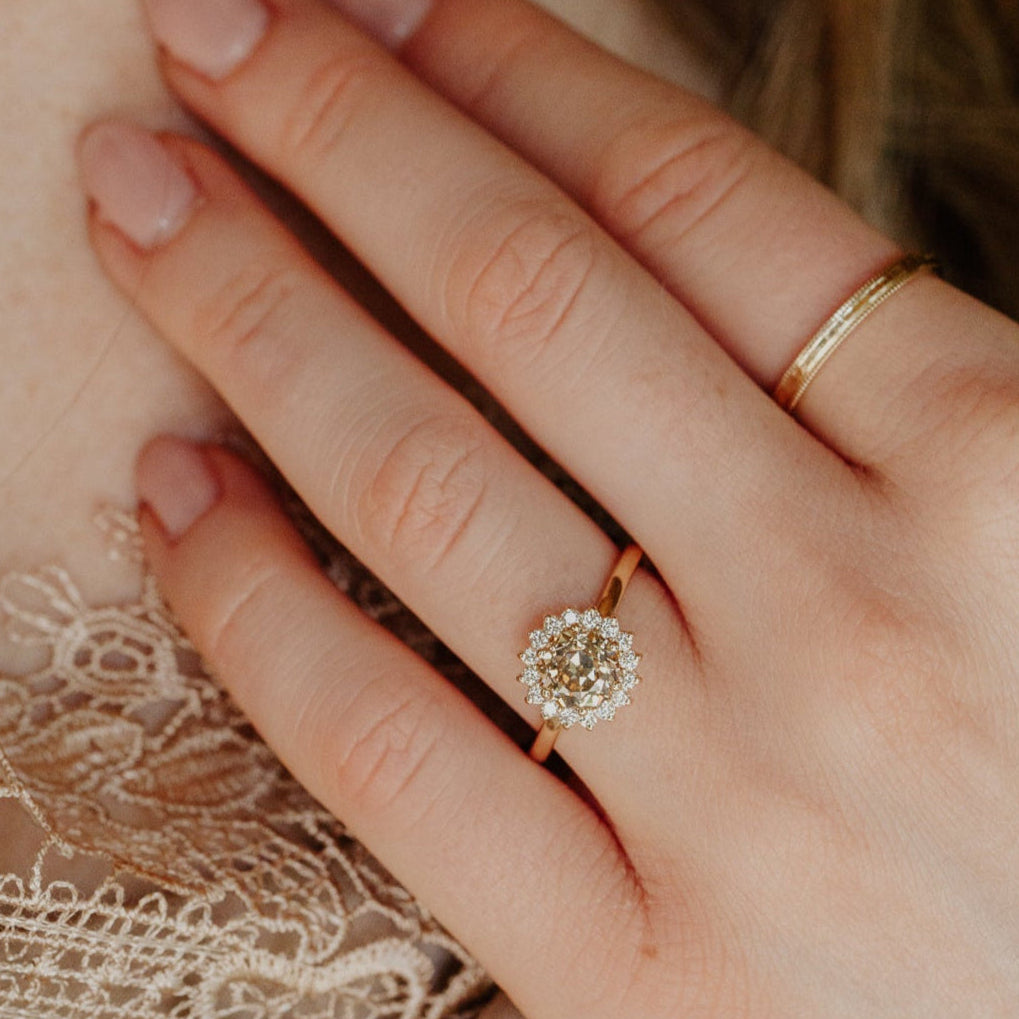 The Camille 1.40 ct Round Old European Cut Champagne Diamond Ring on a models hand