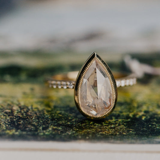 3.31 ct Pear Clear and Peach Rustic Diamond Ring in 14k yellow gold with a natural diamond band