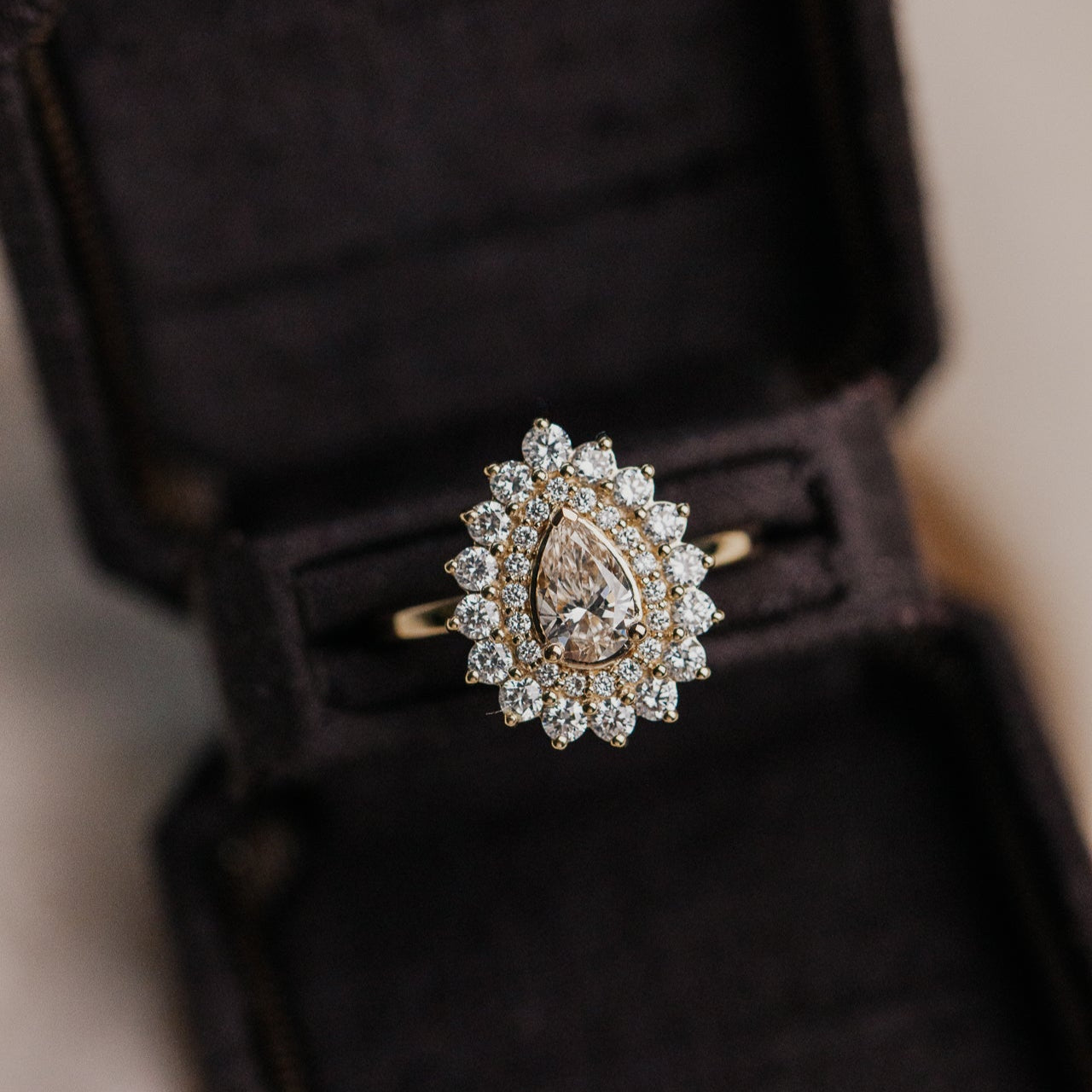 The Marsielle .51 ct Pear Champagne Diamond Ring in a velvet jewelry box