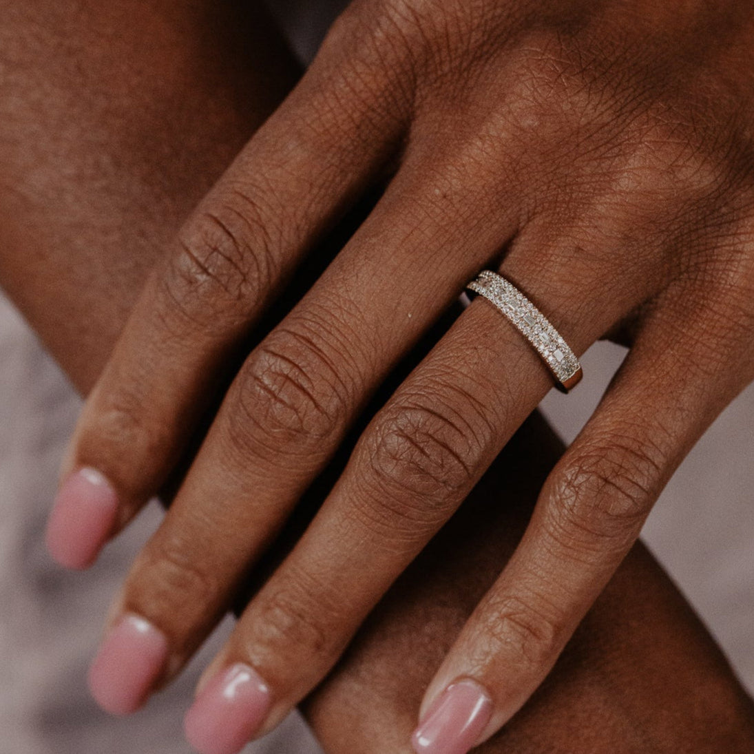 14k gold wedding band with alternating horizontal baguette and round diamonds set between two rows of round pave diamonds.