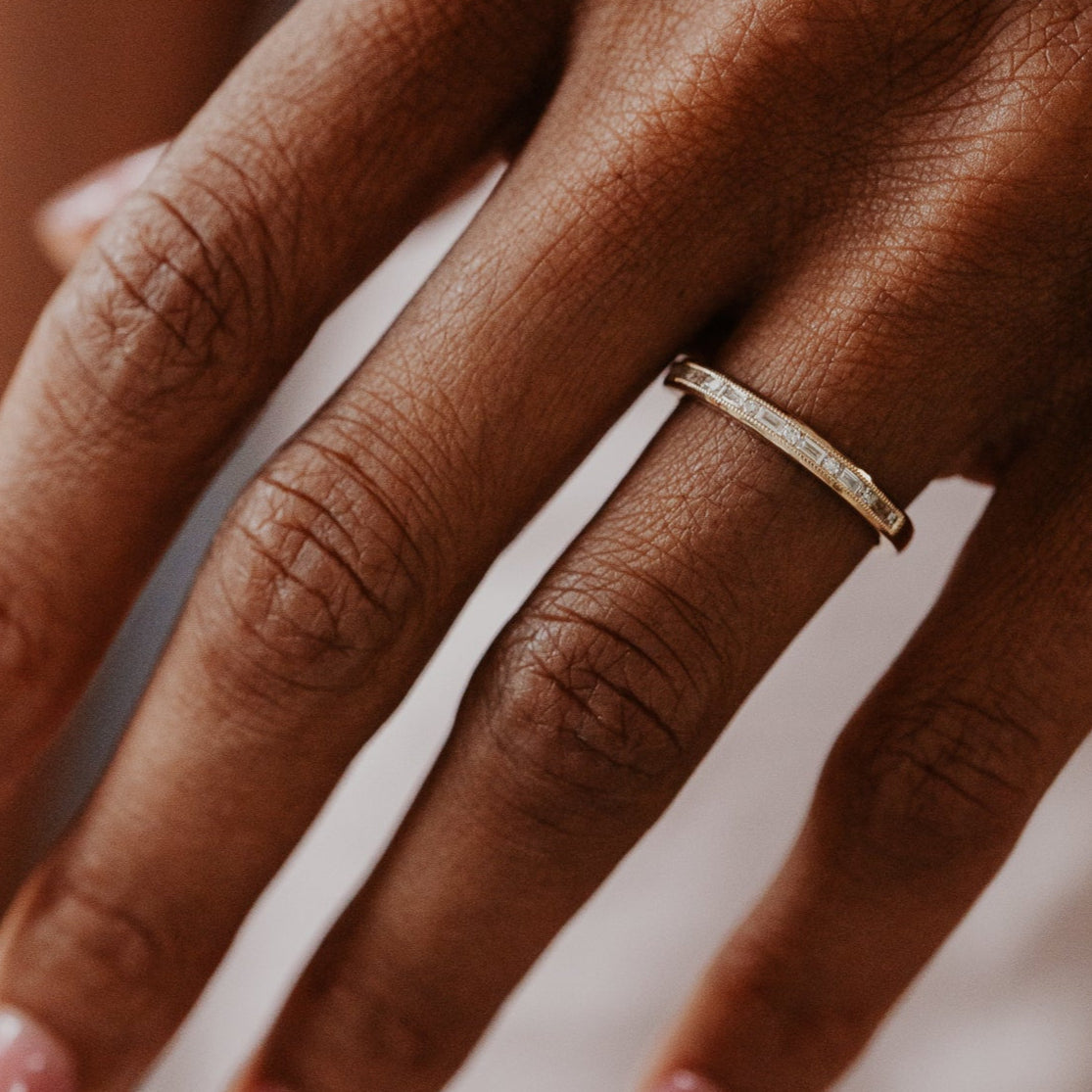 14k gold band featuring ~ .22 cttw baguette and round diamonds set in milgrain detail edges.
