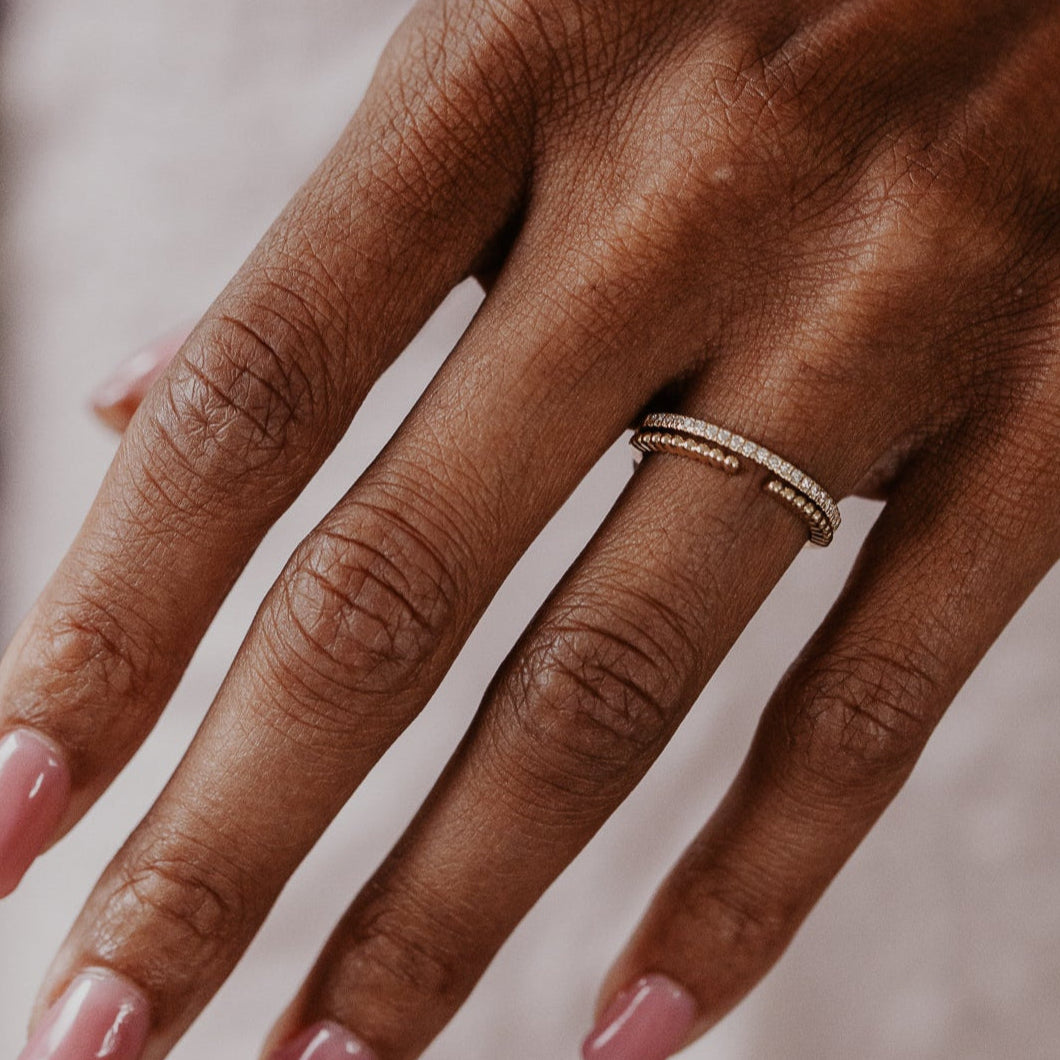 14k gold wedding band featuring a ~.10 cttw pave diamond band, with an open beaded texture band.