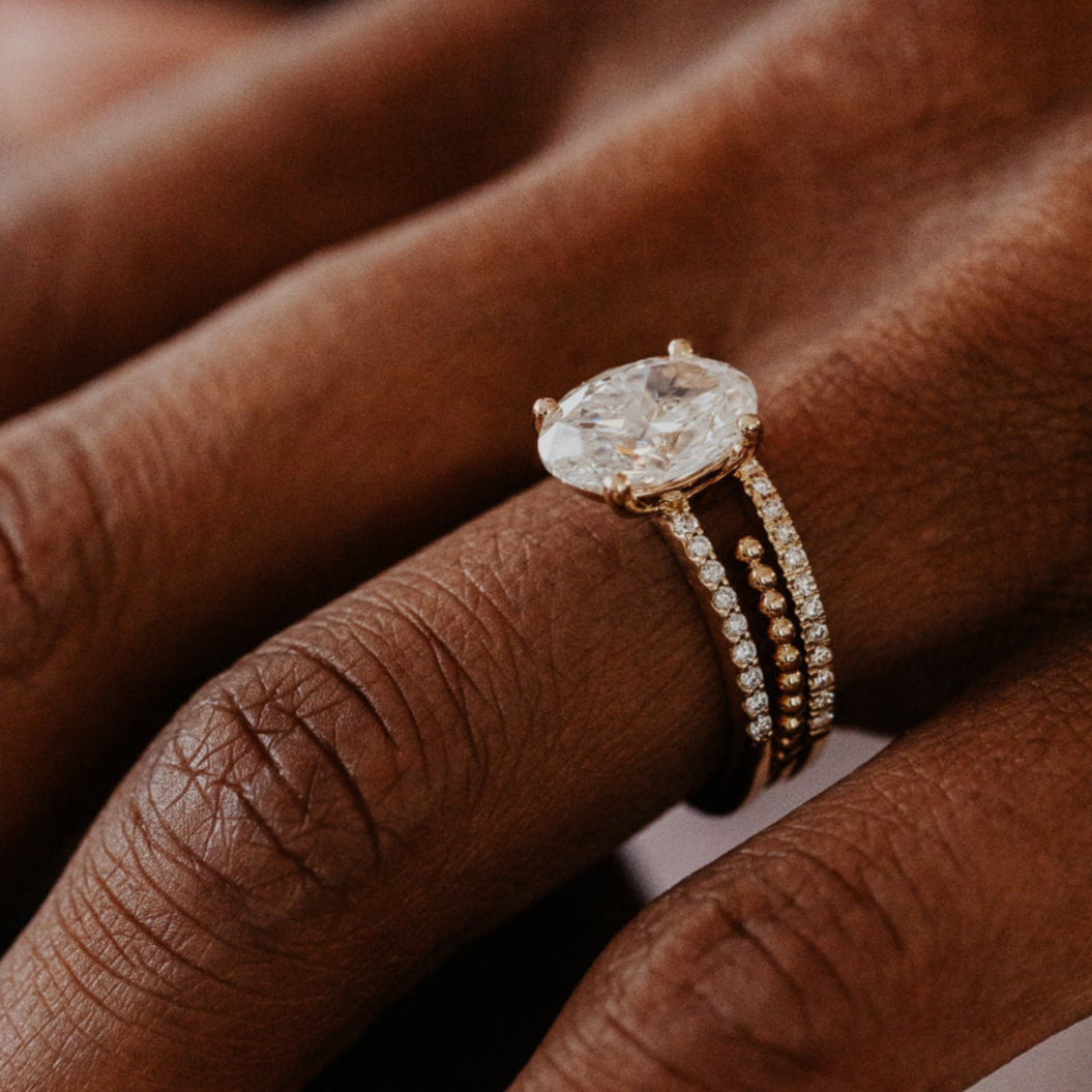 14k gold wedding band featuring a ~.10 cttw pave diamond band, with an open beaded texture band.
