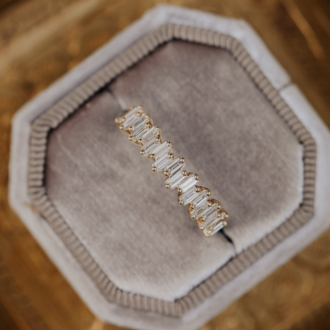 14k gold band featuring ~.48 cttw baguette diamonds set in a staggered design.