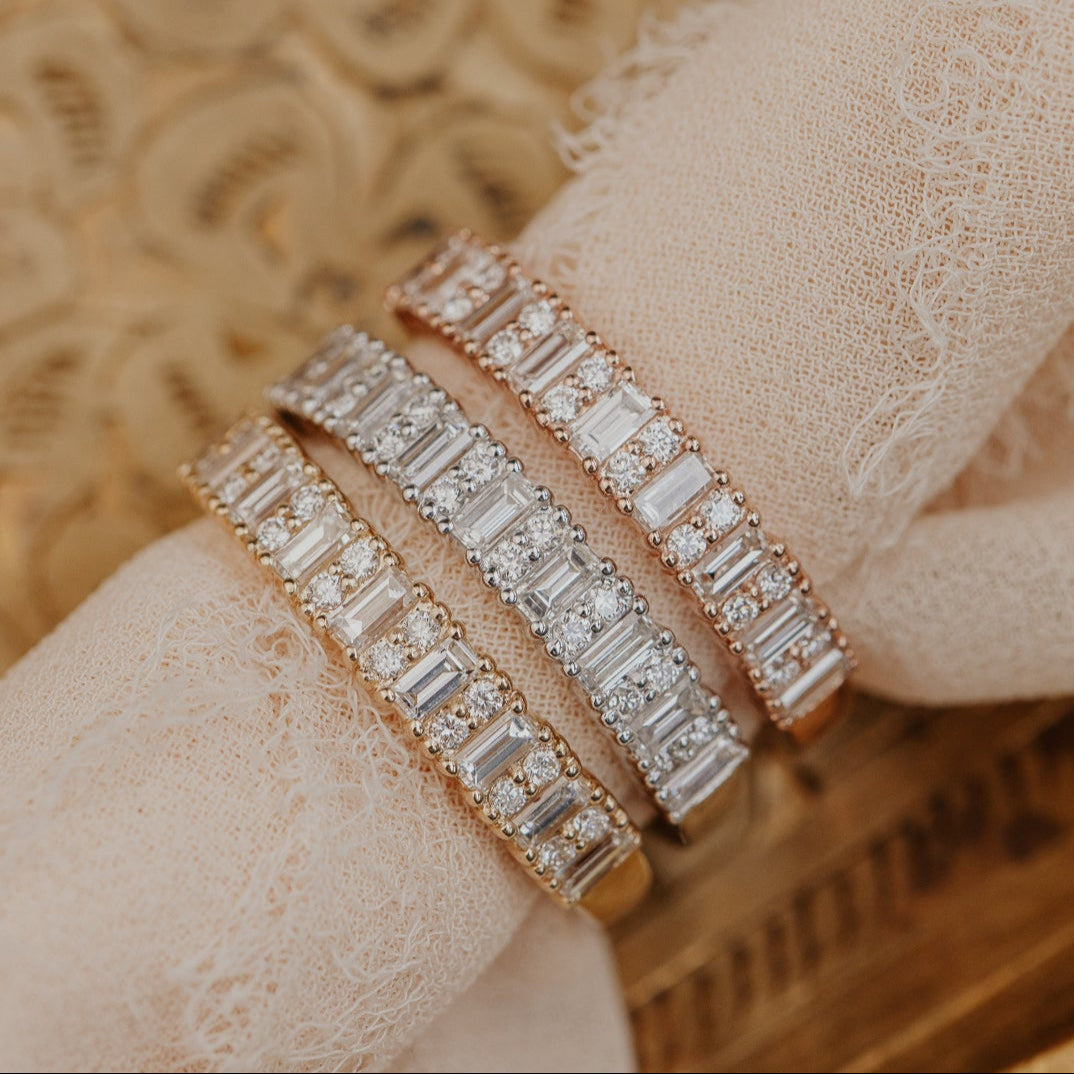 14k gold band featuring ~.49 cttw baguette and double round diamonds set in prongs in an alternating design 