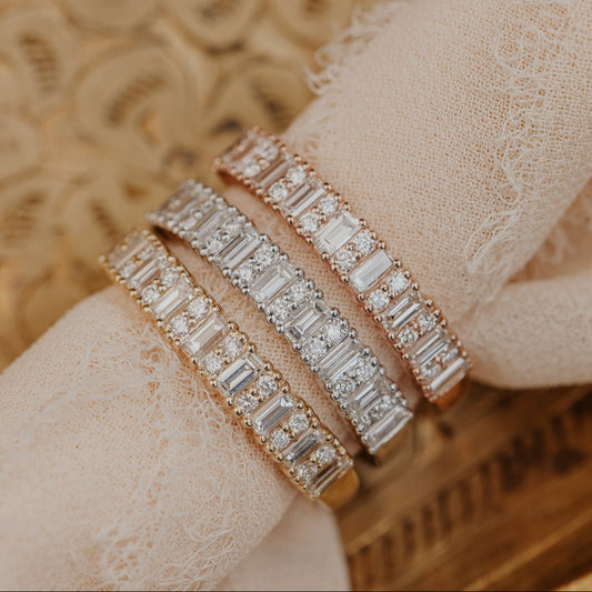 14k gold band featuring ~.49 cttw baguette and double round diamonds set in prongs in an alternating design 