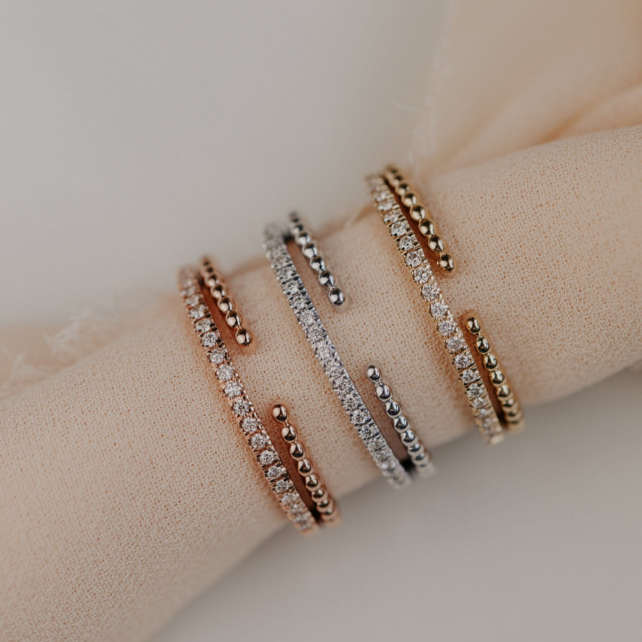 14k gold wedding band featuring a ~.10 cttw pave diamond band, with an open beaded texture band.