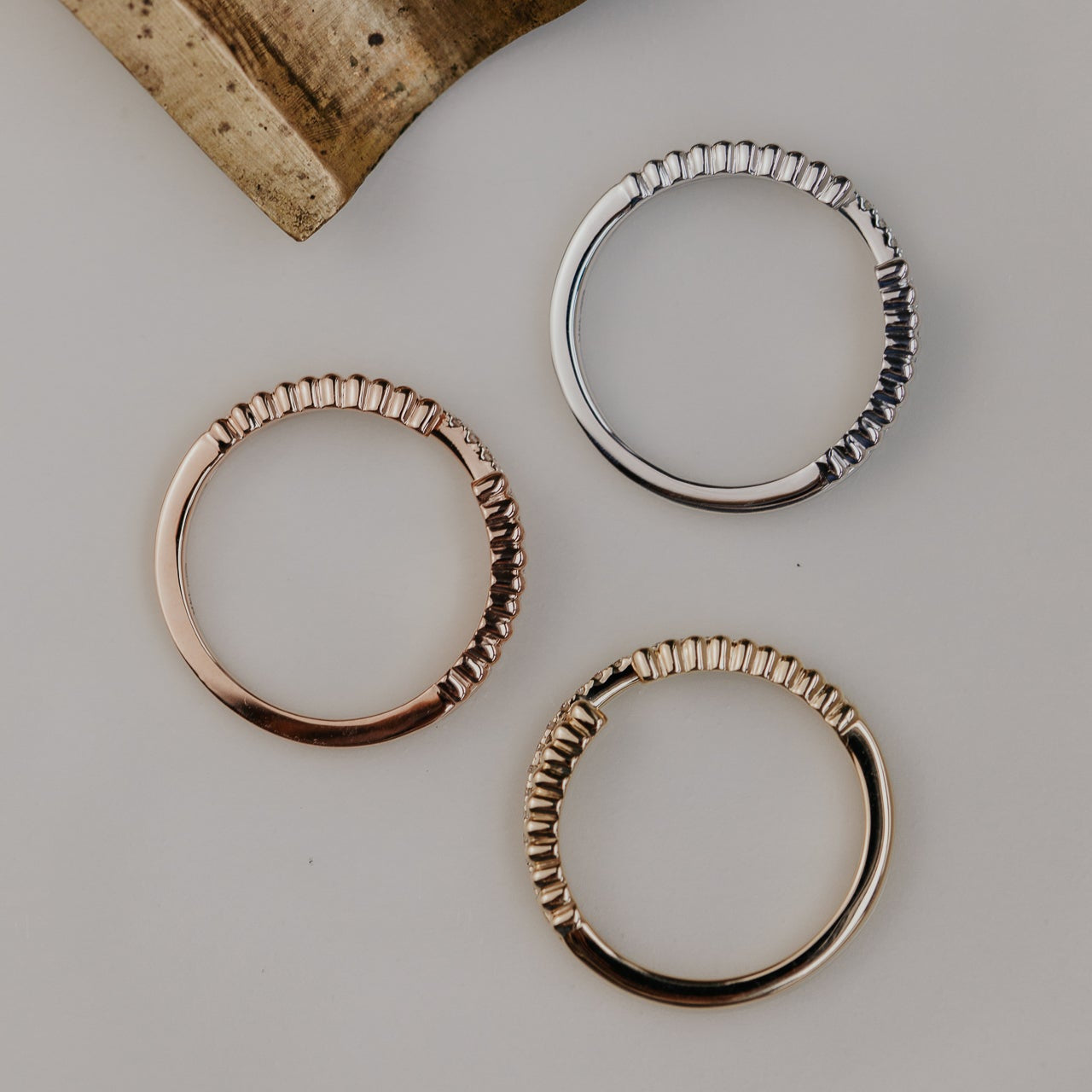 14k gold wedding band featuring a ~.10 cttw pave diamond band, with an open beaded texture band.