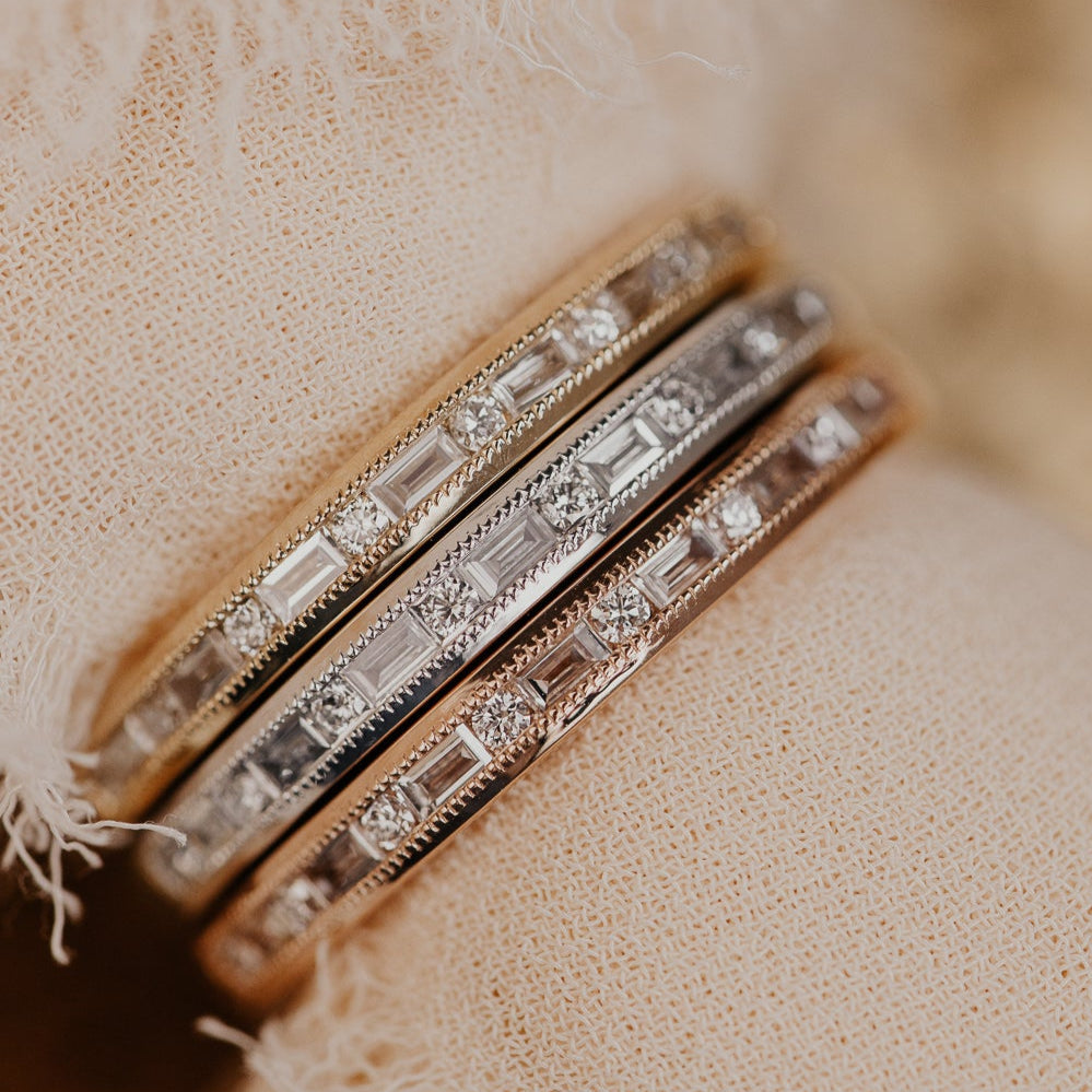 14k gold band featuring ~ .22 cttw baguette and round diamonds set in milgrain detail edges.