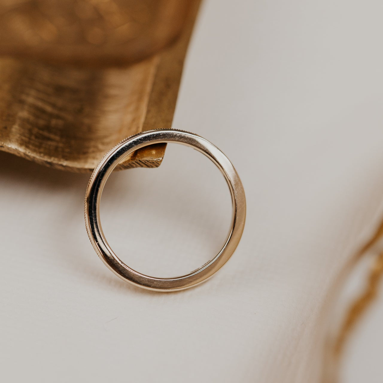 14k gold band featuring ~ .22 cttw baguette and round diamonds set in milgrain detail edges.