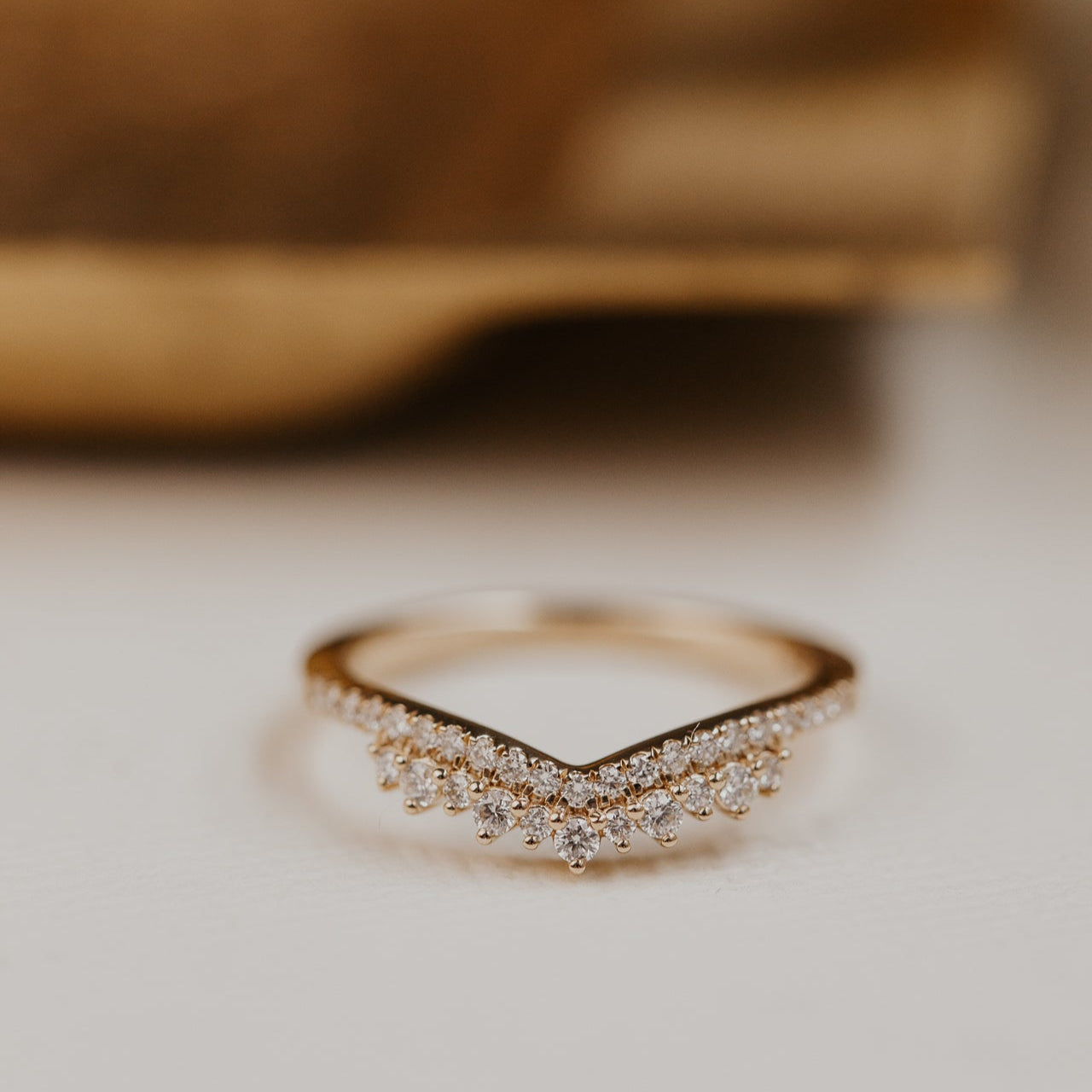 14k gold starburst tracer band featuring ~.24 cttw round pave diamonds set in a v tracer design