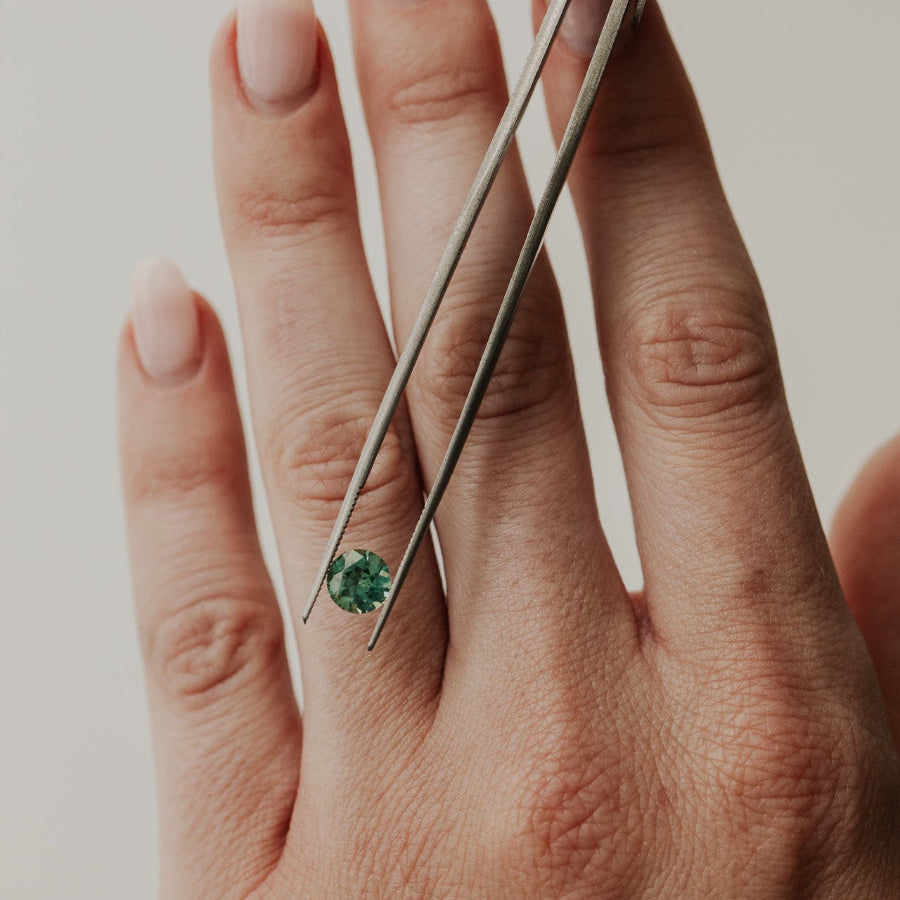  1.17 ct Round Green Australian Sapphire on models hand